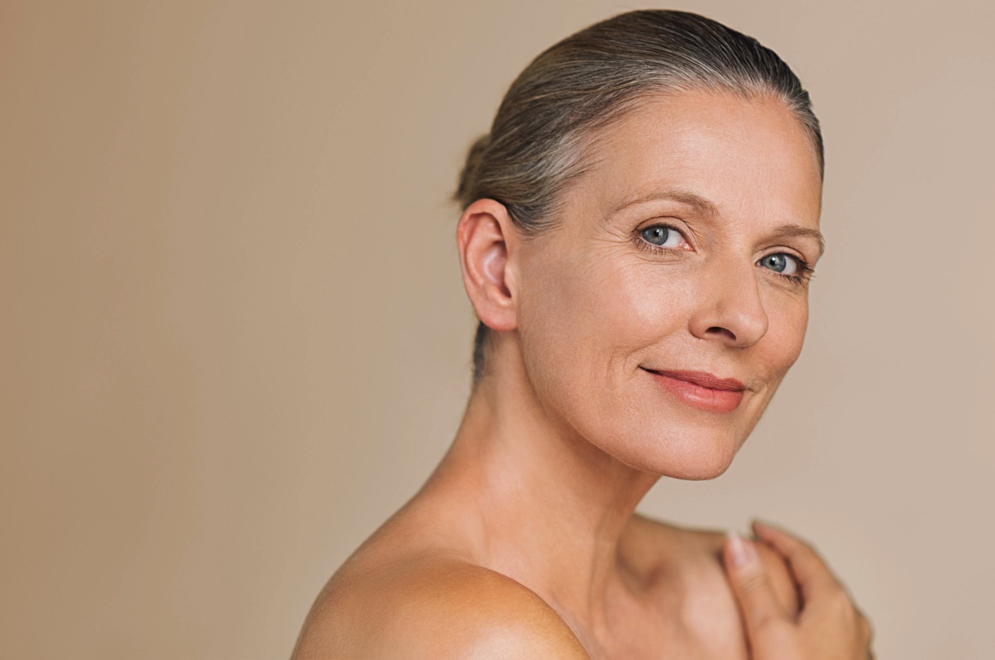 Photo of woman looking at the camera with her hair tied back having applied AvenaPLex.